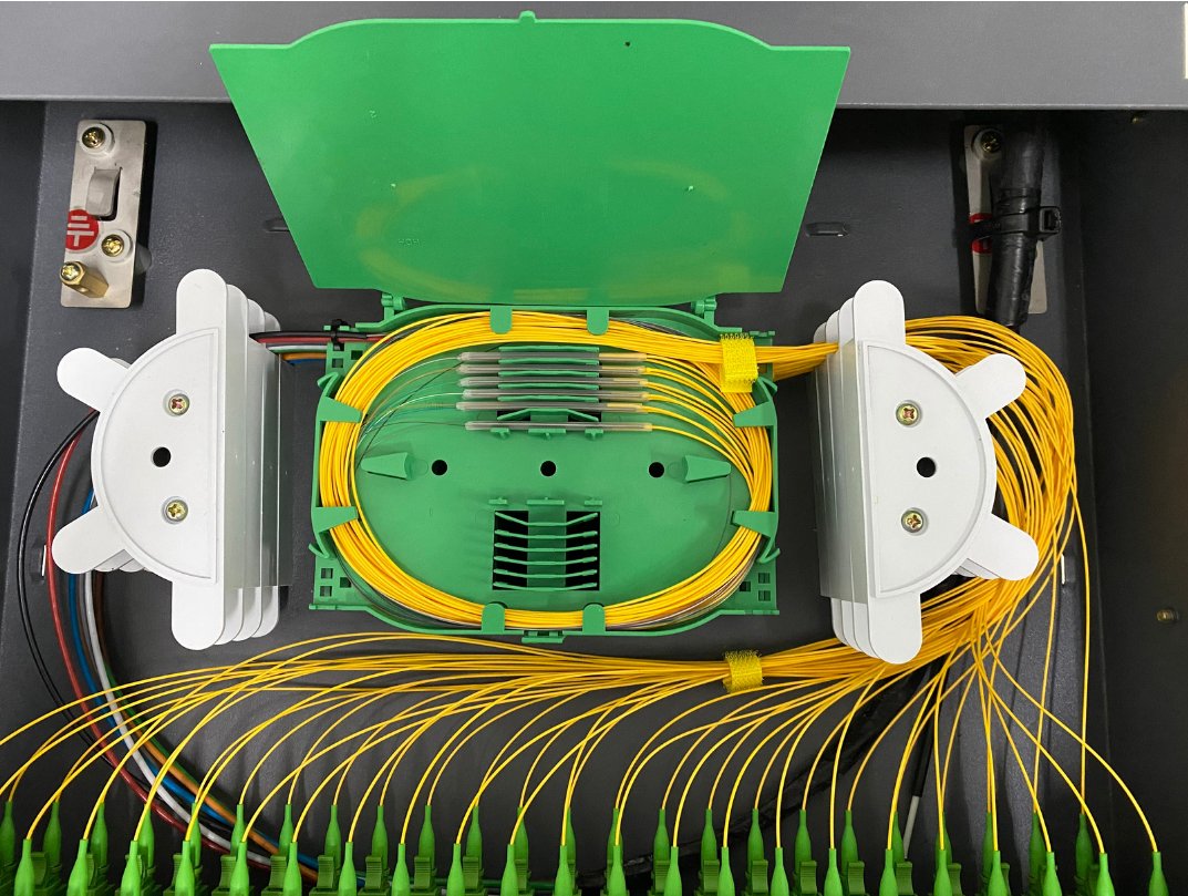 Open fiber optic distribution panel with neatly routed yellow patch cords